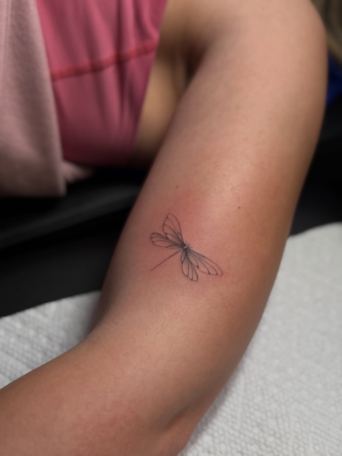 Dragonfly fine line tattoo on the forearm by DFW Fineline Tattoo Artist