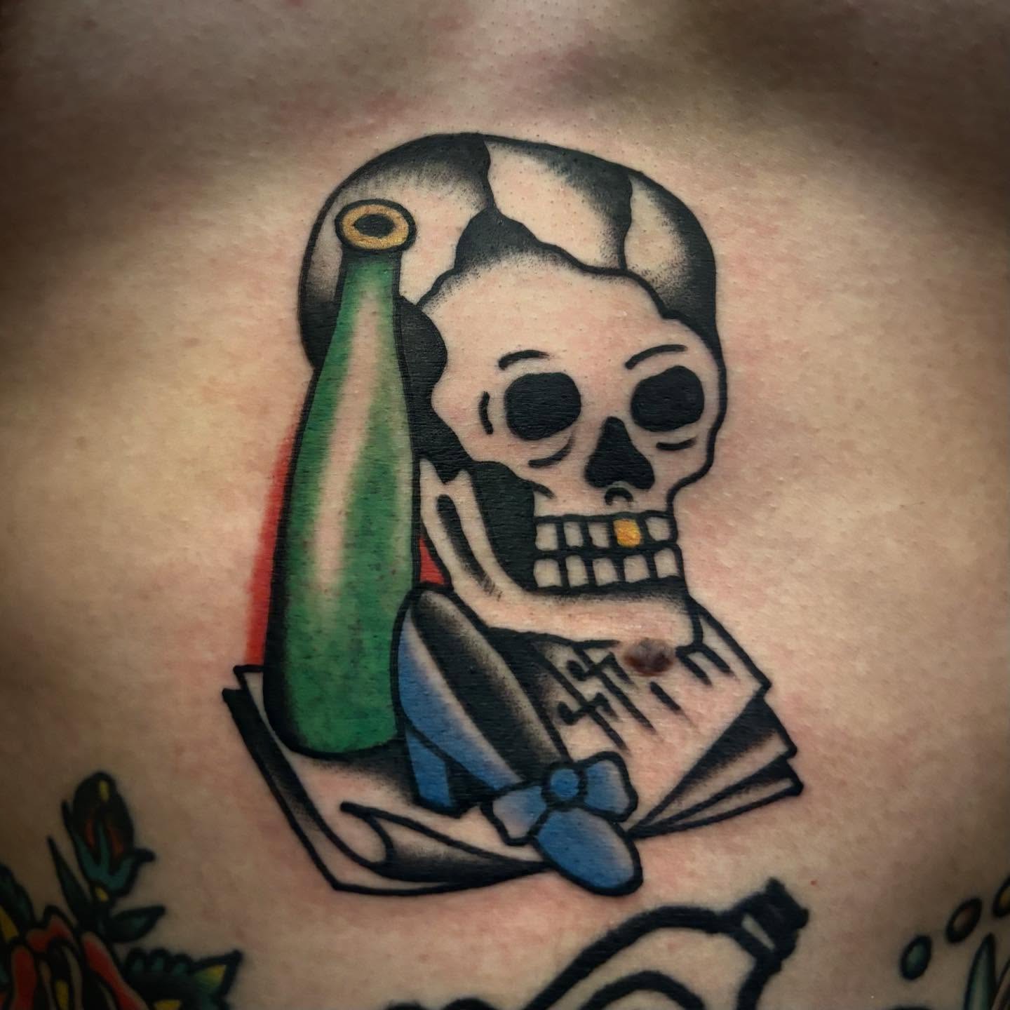 Skull with bottle American traditional tattoo on the chest by Danny DiBlasi, San Francisco, California