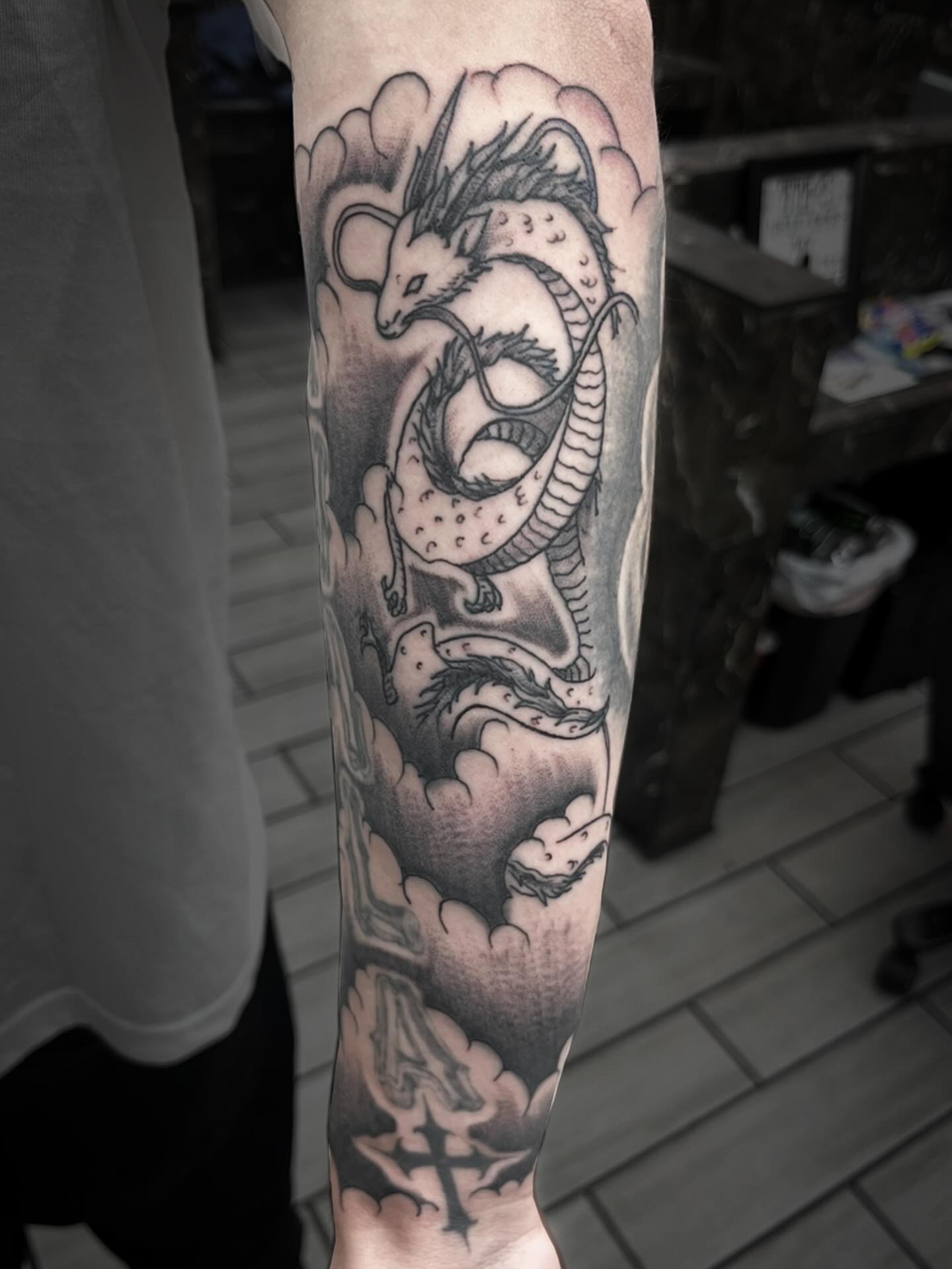 Dragon black and grey tattoo on the forearm by Sean Gallagher