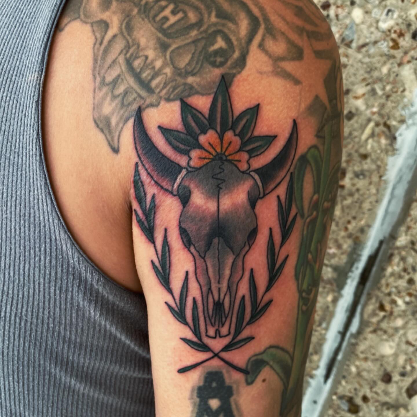 Bull skull with flower American traditional tattoo on the forearm by Houston tattoo artist
