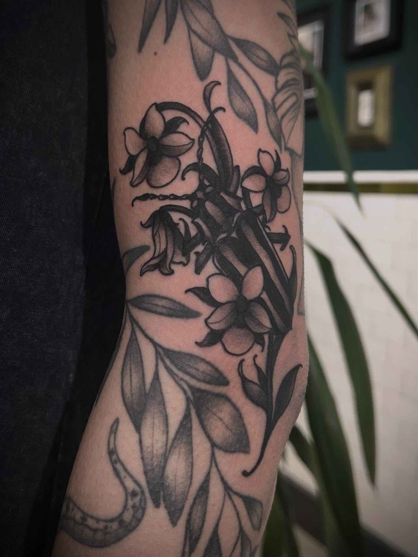 Lily flowers black and grey tattoo on the forearm by ꧁𝙺𝚊𝚛𝚒𝚗𝚊꧂, Grinnell, Iowa
