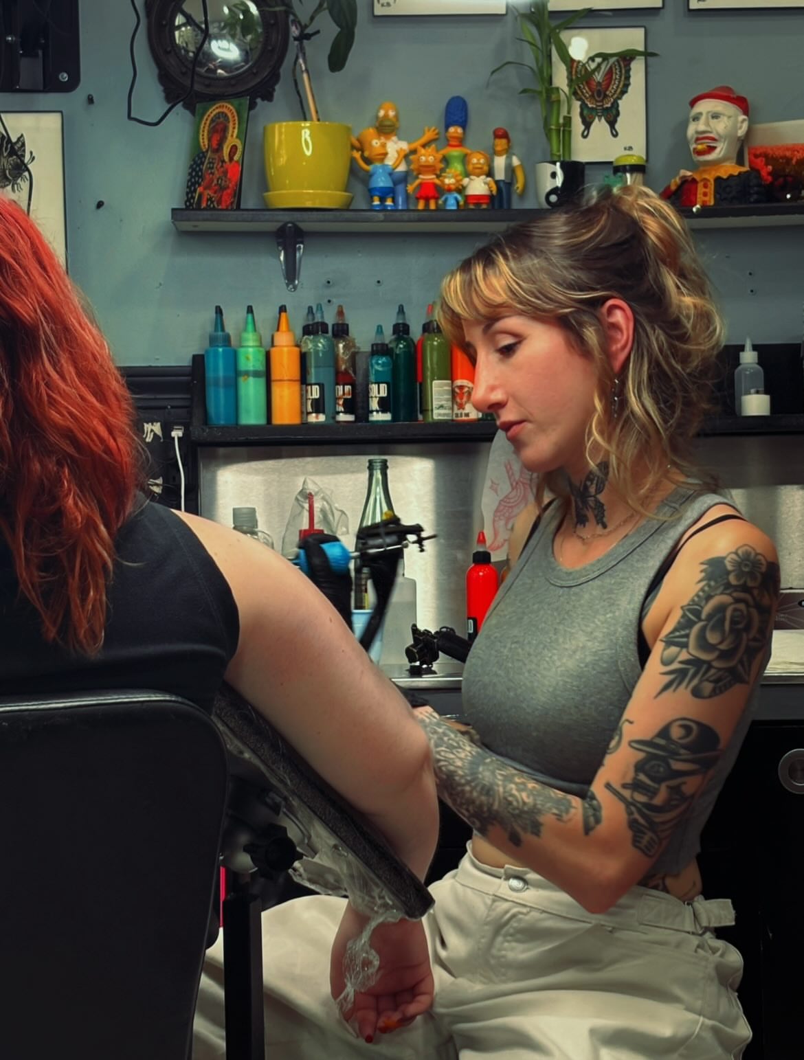 Rose and skull American traditional tattoo on the upper arm by Kat, Sacramento, California