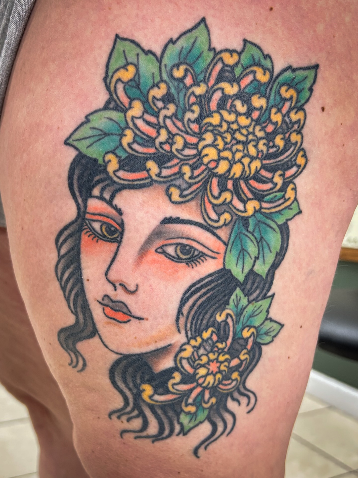 Floral portrait American traditional tattoo on the thigh by Jessica Oram Brockman, Dayton, Ohio