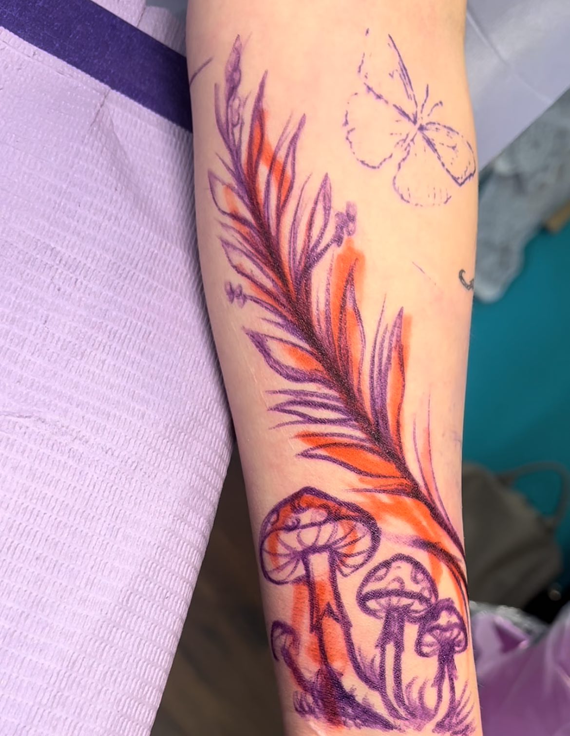 Feather and mushrooms dotwork tattoo on the forearm by Chelsea Nichole