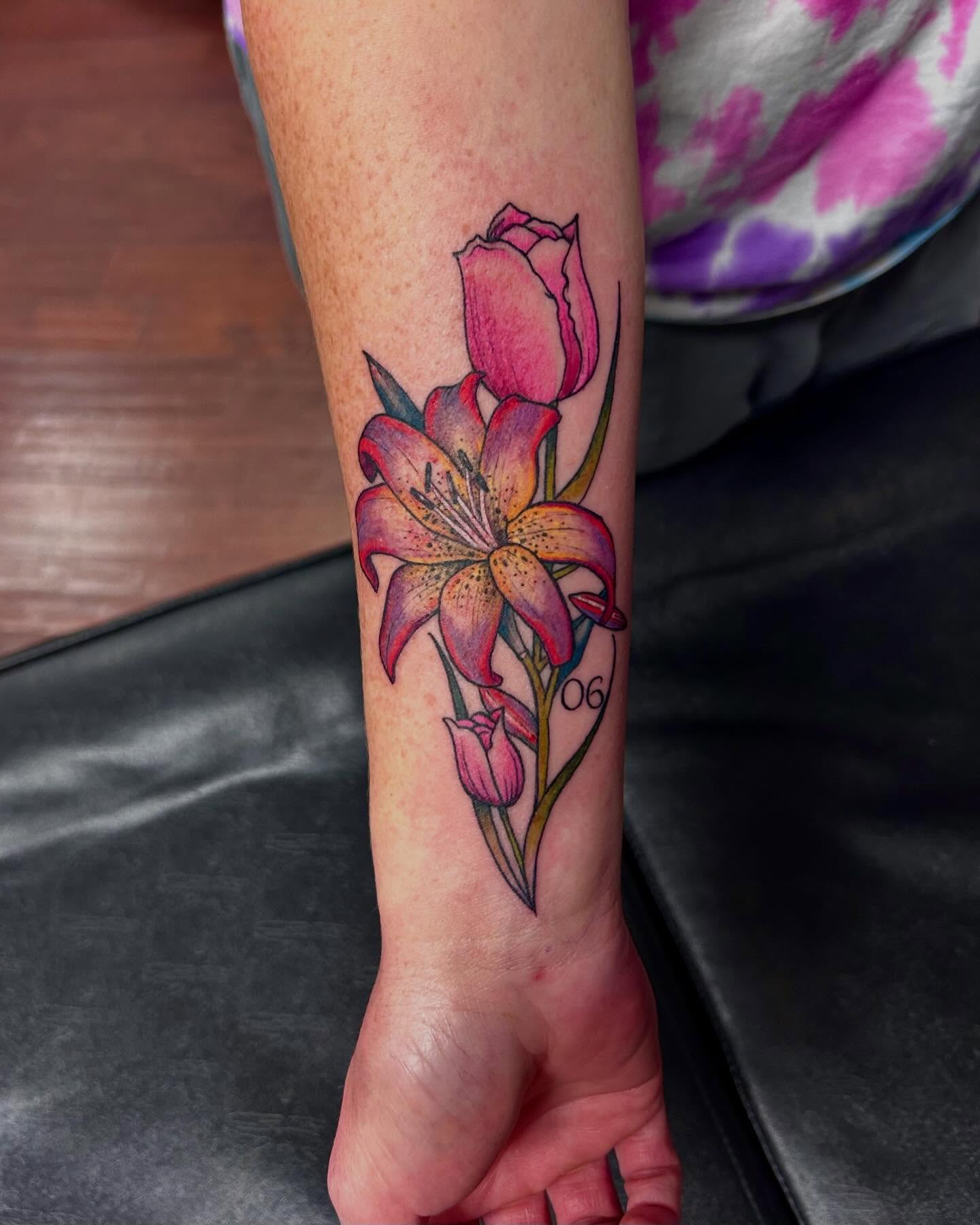 Lilies and tulips realism tattoo on the forearm by Jon Byrd