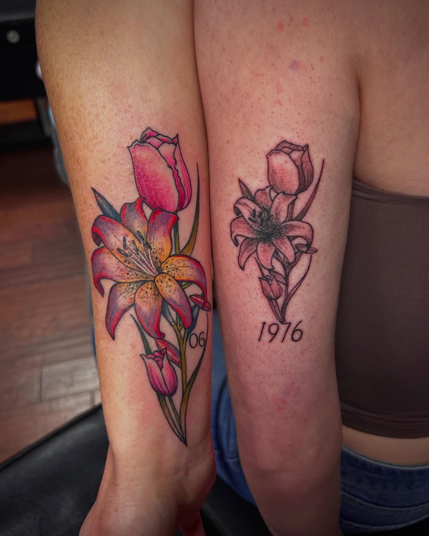Lilies and roses realism tattoo on the forearm by Jon Byrd