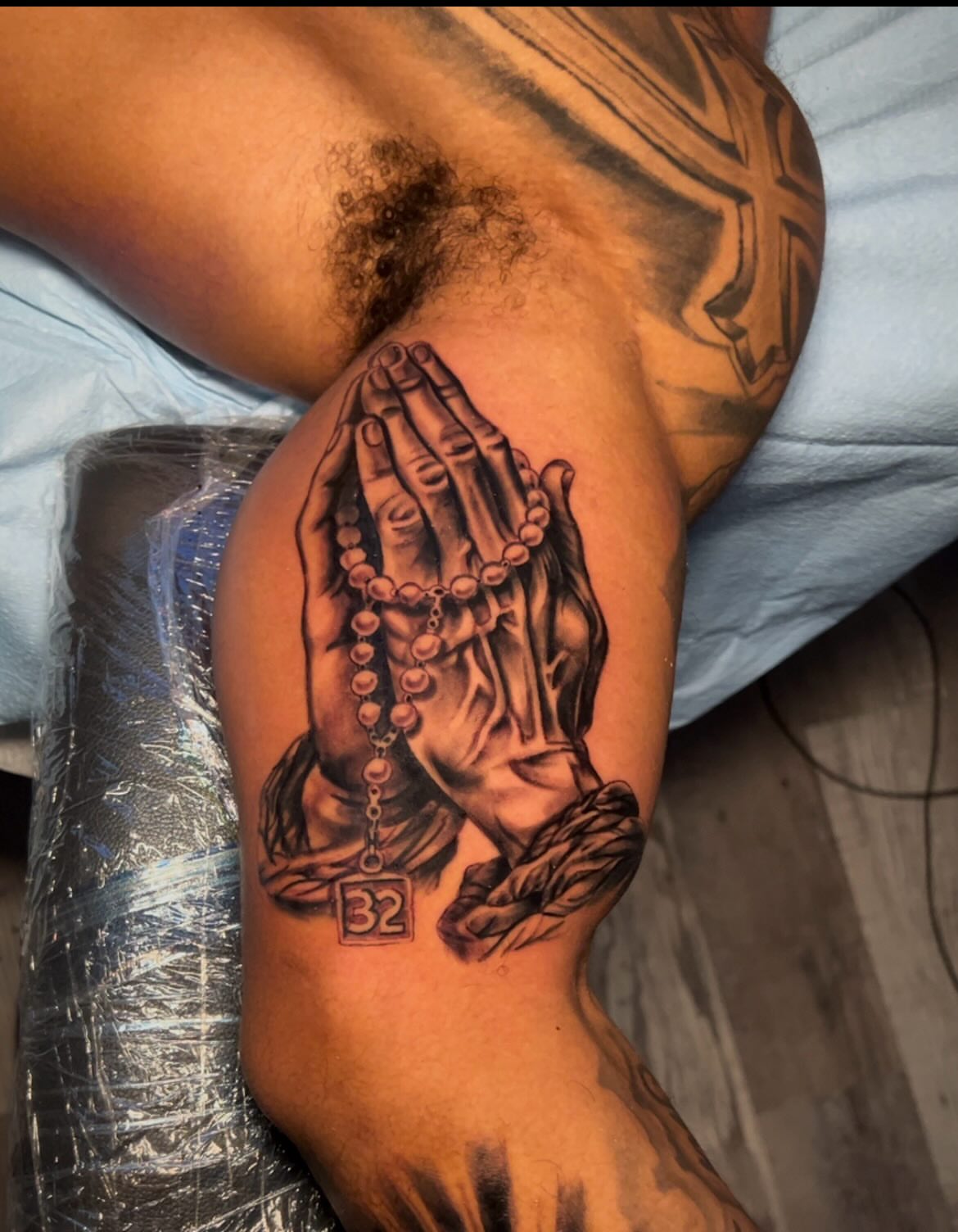 Praying hands realism tattoo on the forearm by Lucky Lefty