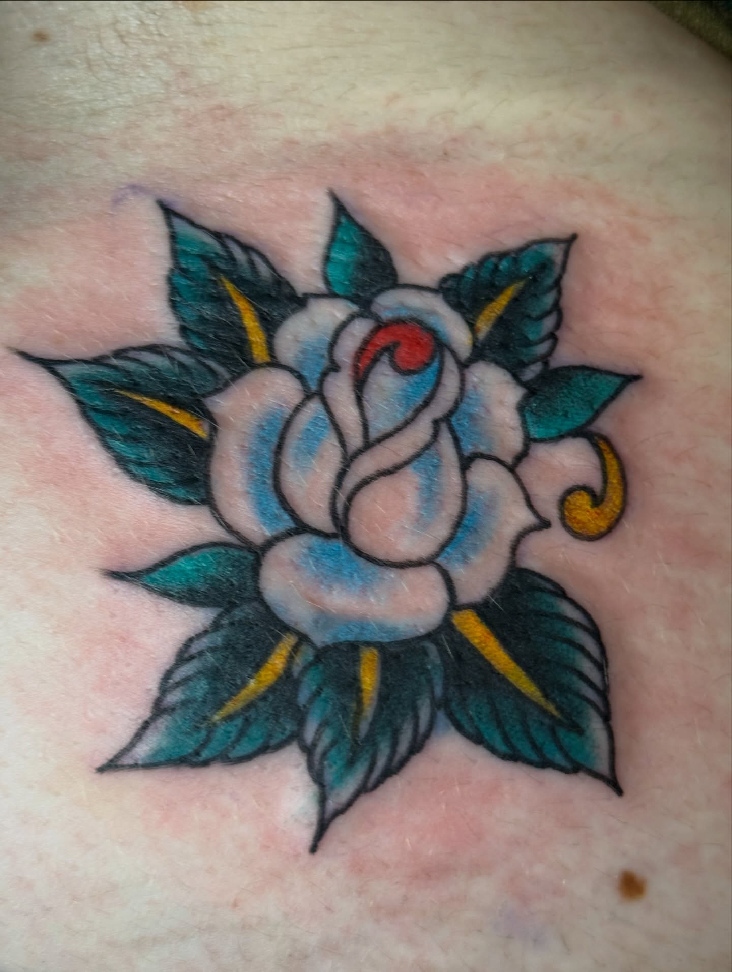 Rose American traditional tattoo on the chest by Ben Karnofsky