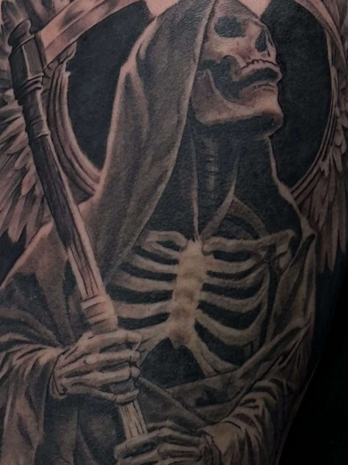 Grim reaper realism tattoo on the upper arm by Matthew Doherty