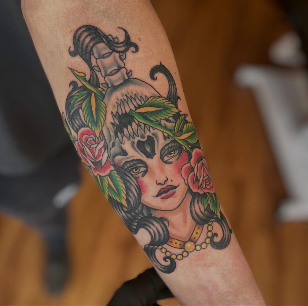 Woman with roses American traditional tattoo on the forearm by Taylor Santavicca
