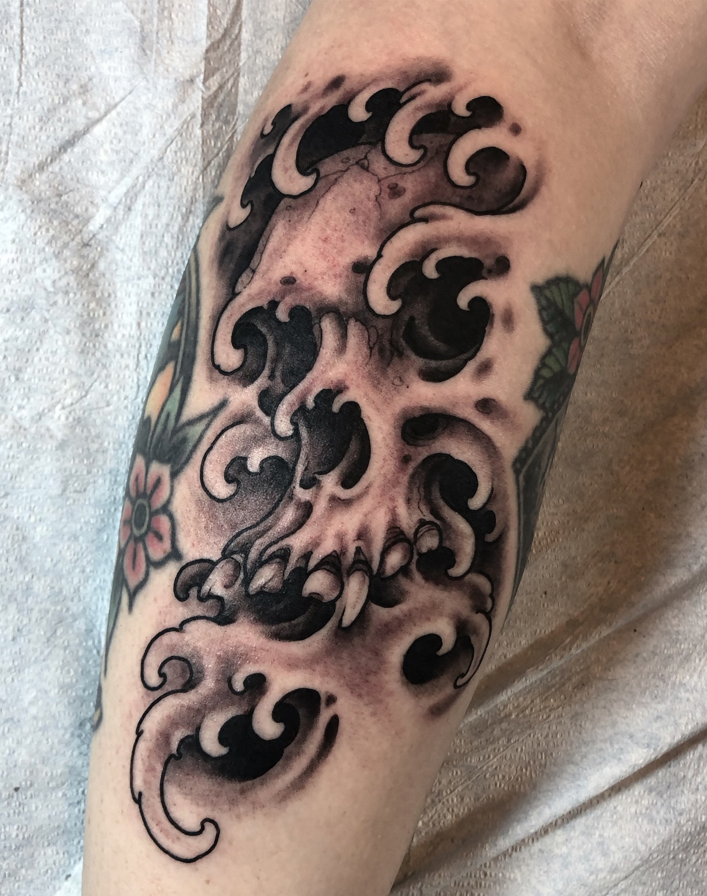 Wave black and grey tattoo on the forearm by Justin Weatherholtz, New York, New York
