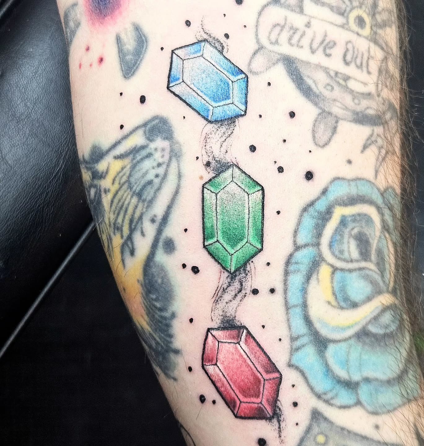 Gemstones geometric tattoo on the forearm by Damian Eames