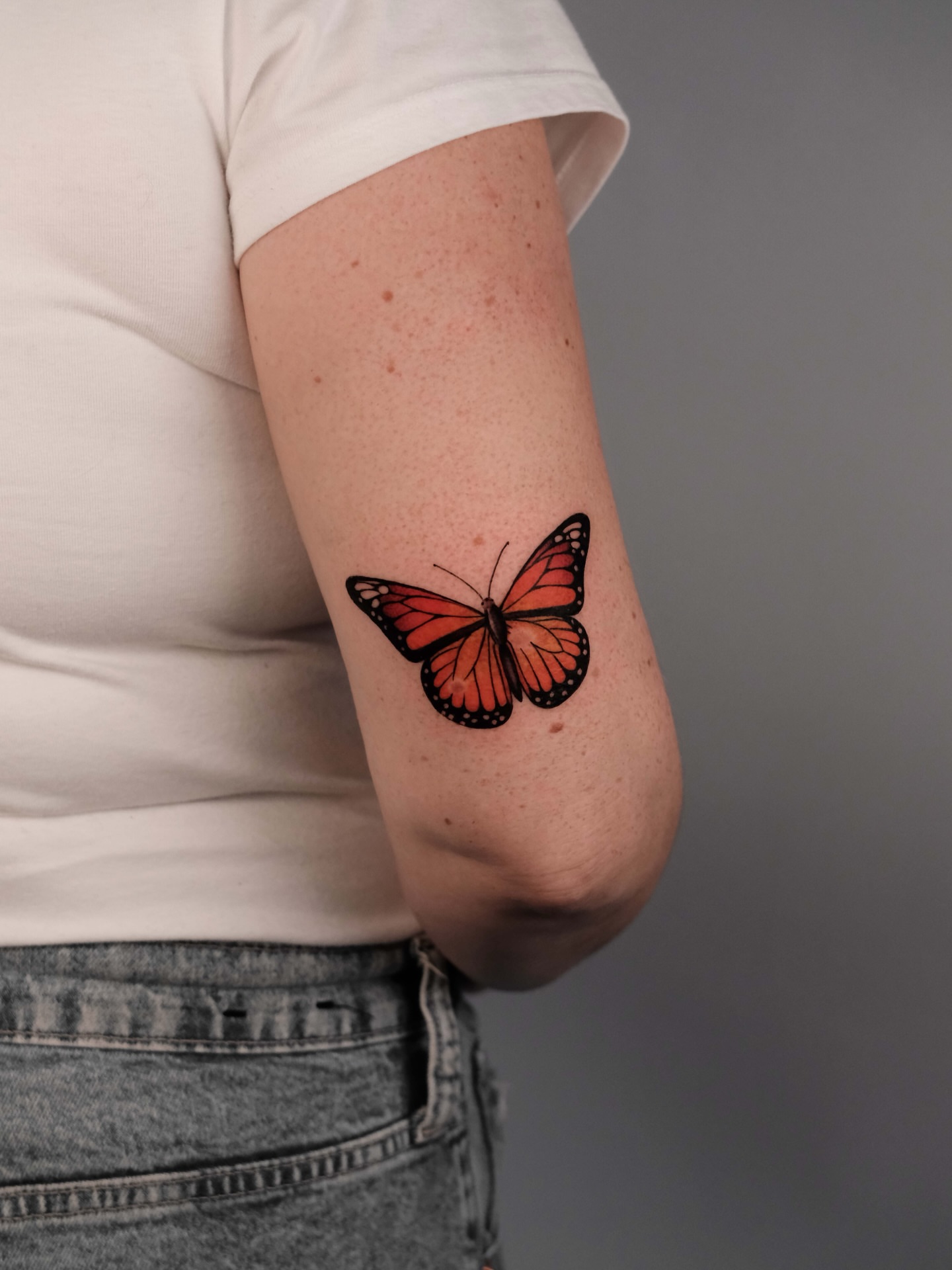 Monarch butterfly realism tattoo on the forearm by Anastasiia