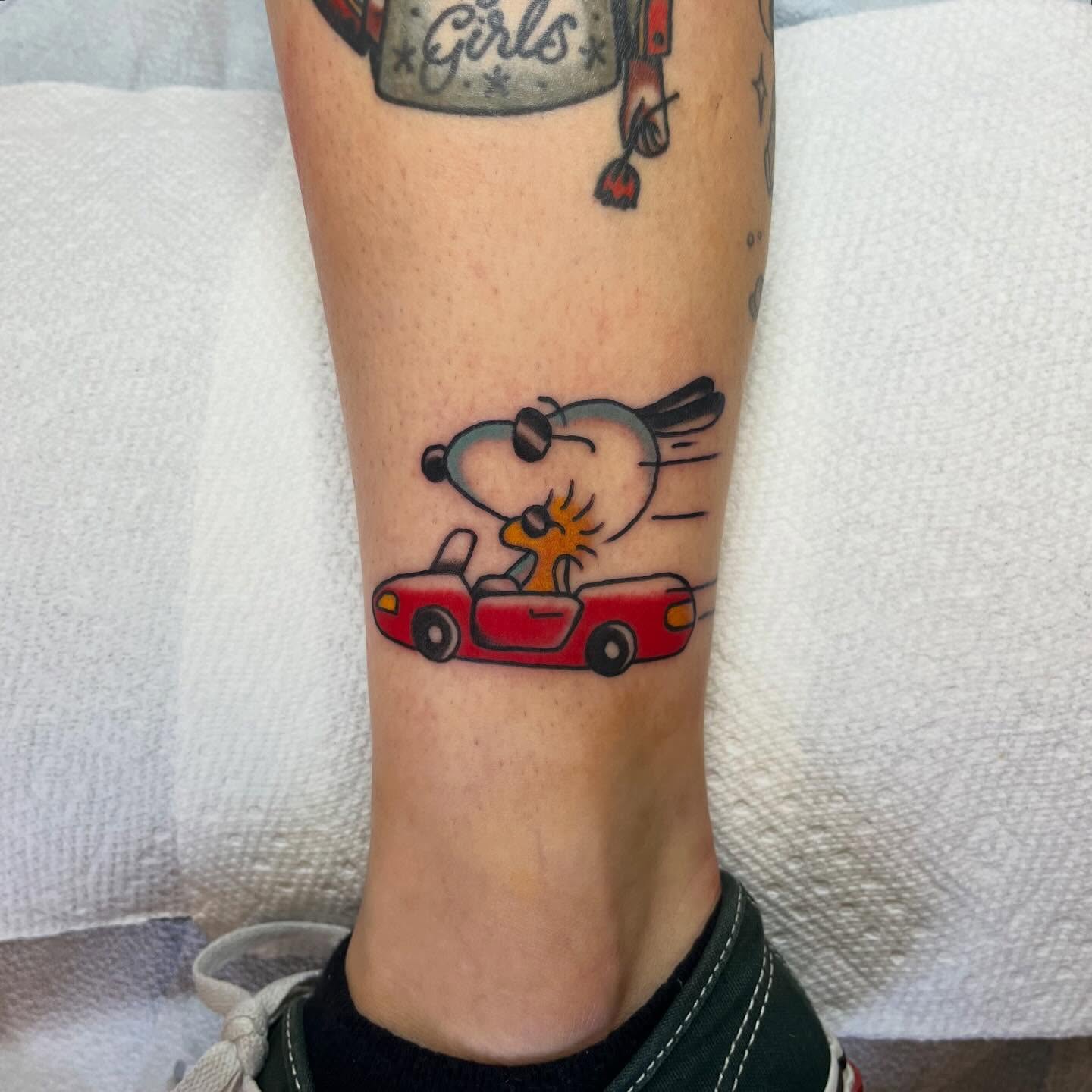 Snoopy driving car illustrative tattoo on the forearm by Elizabeth Summers ❨・¨⬮ Traditional Tattoo