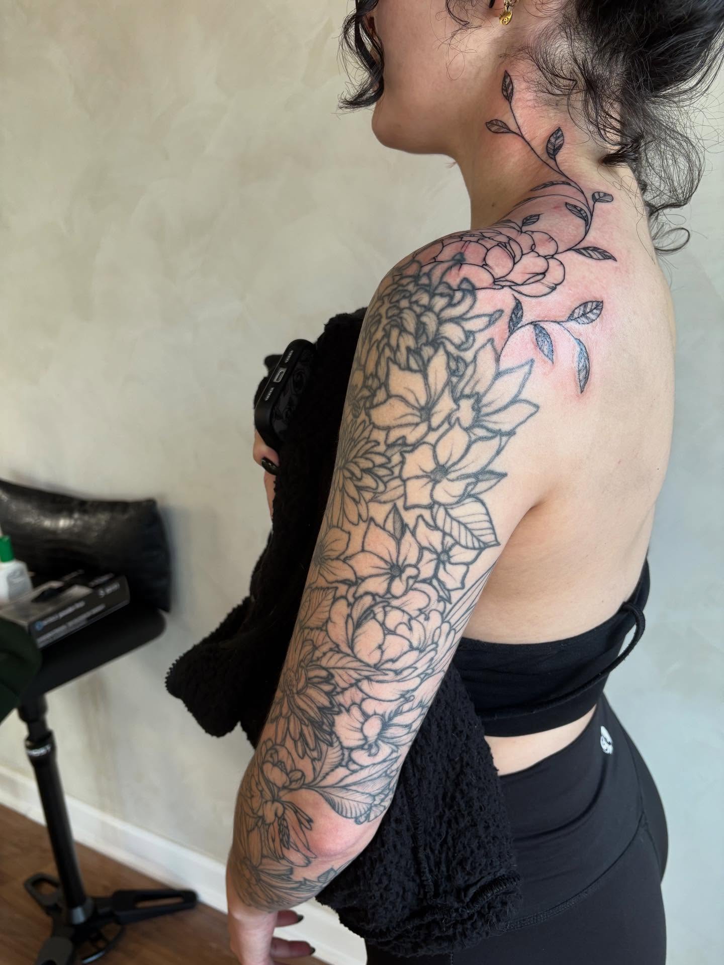 Floral black and grey tattoo on the shoulder by Dallas Davis