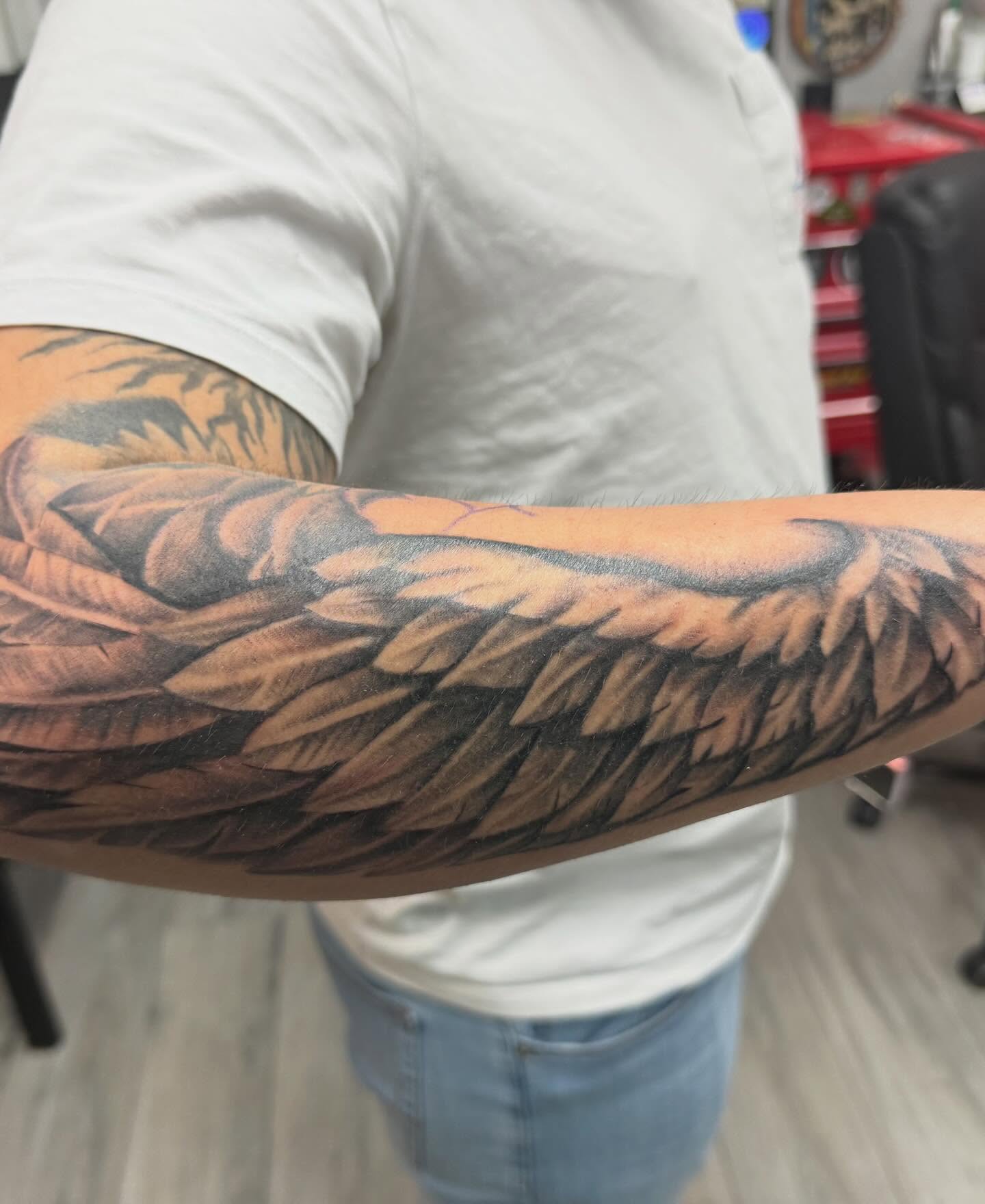 Wing realism tattoo on the forearm by Daniel Smith