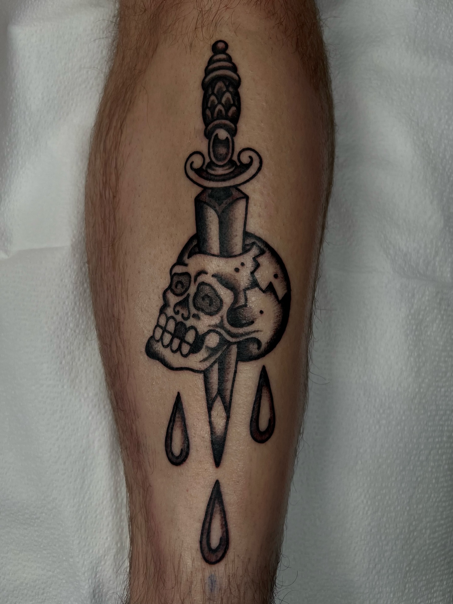 Skull and dagger black and grey tattoo on the forearm by Cassidy Maples