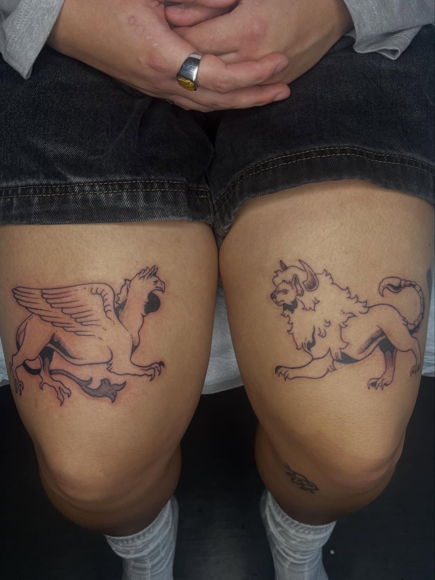 Mythical creature black and grey tattoo on the thigh by Gabbie