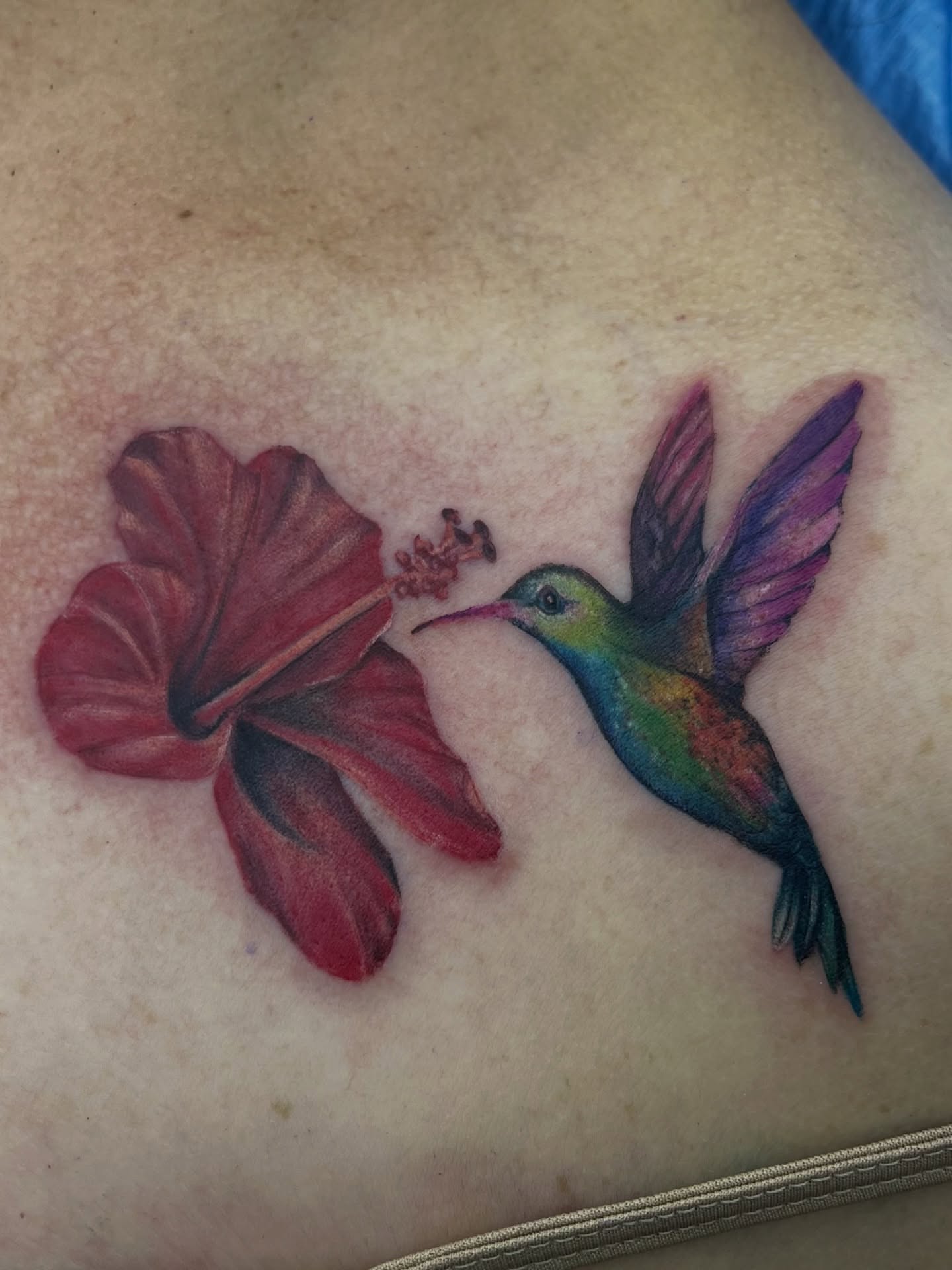 Hummingbird and flower realism tattoo on the chest by Georgianna Ink, Las Vegas, Nevada