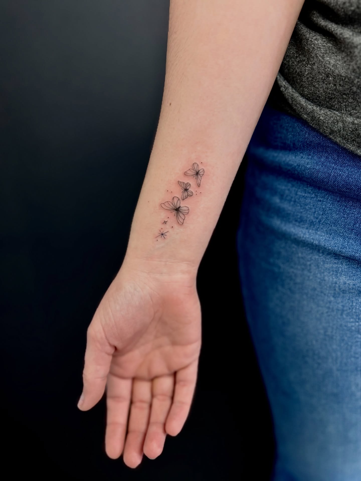 Butterflies dotwork tattoo on the forearm by Reverie Studio