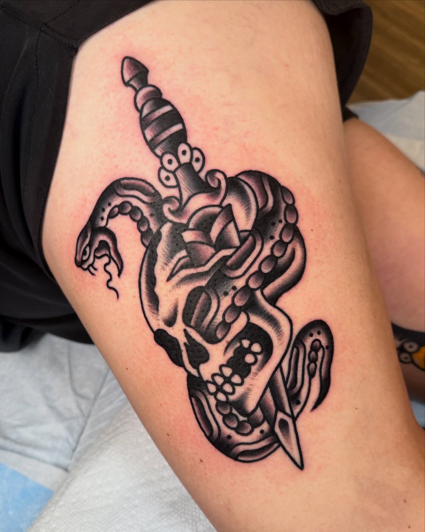 Skull with snake American traditional tattoo on the thigh by Cullen Bleser Quinn