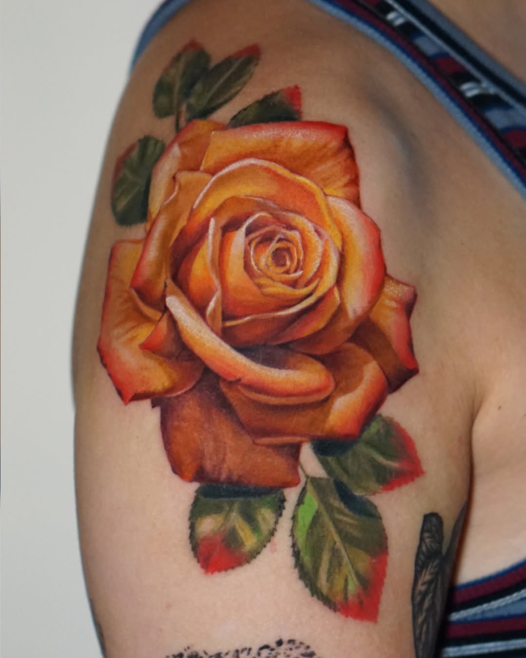 Orange rose neo-traditional tattoo on the shoulder by San Diego Color Realism and Neotraditional