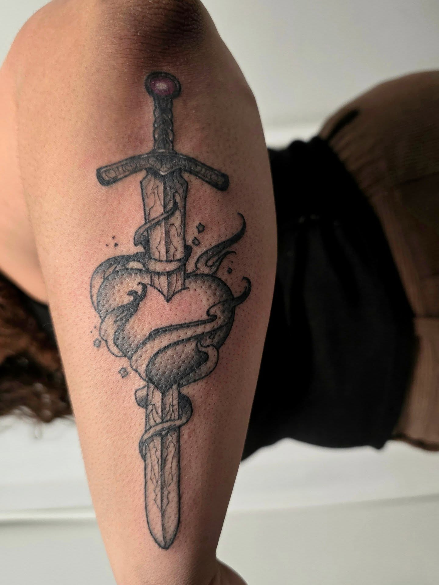 Sword through heart black and grey tattoo on the forearm by April High ☆ Tattoo Artist