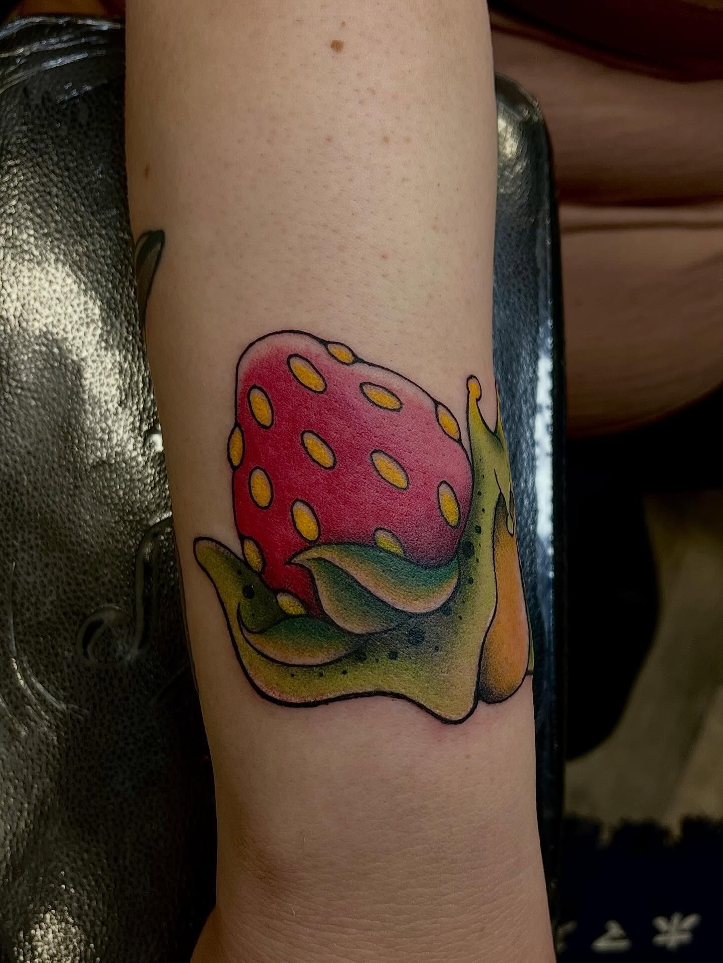 Snail with strawberry shell dotwork tattoo on the forearm by Chase Healey, Salt Lake City, Utah