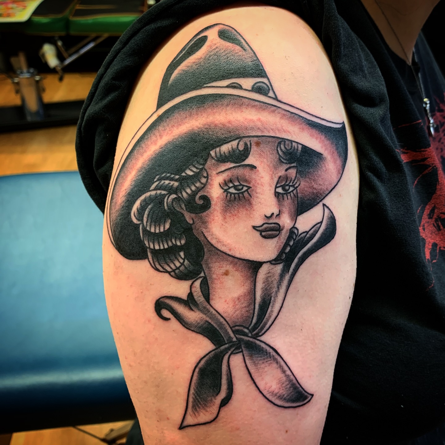 Woman wearing hat American traditional tattoo on the shoulder by Tattoos Las Vegas,NV