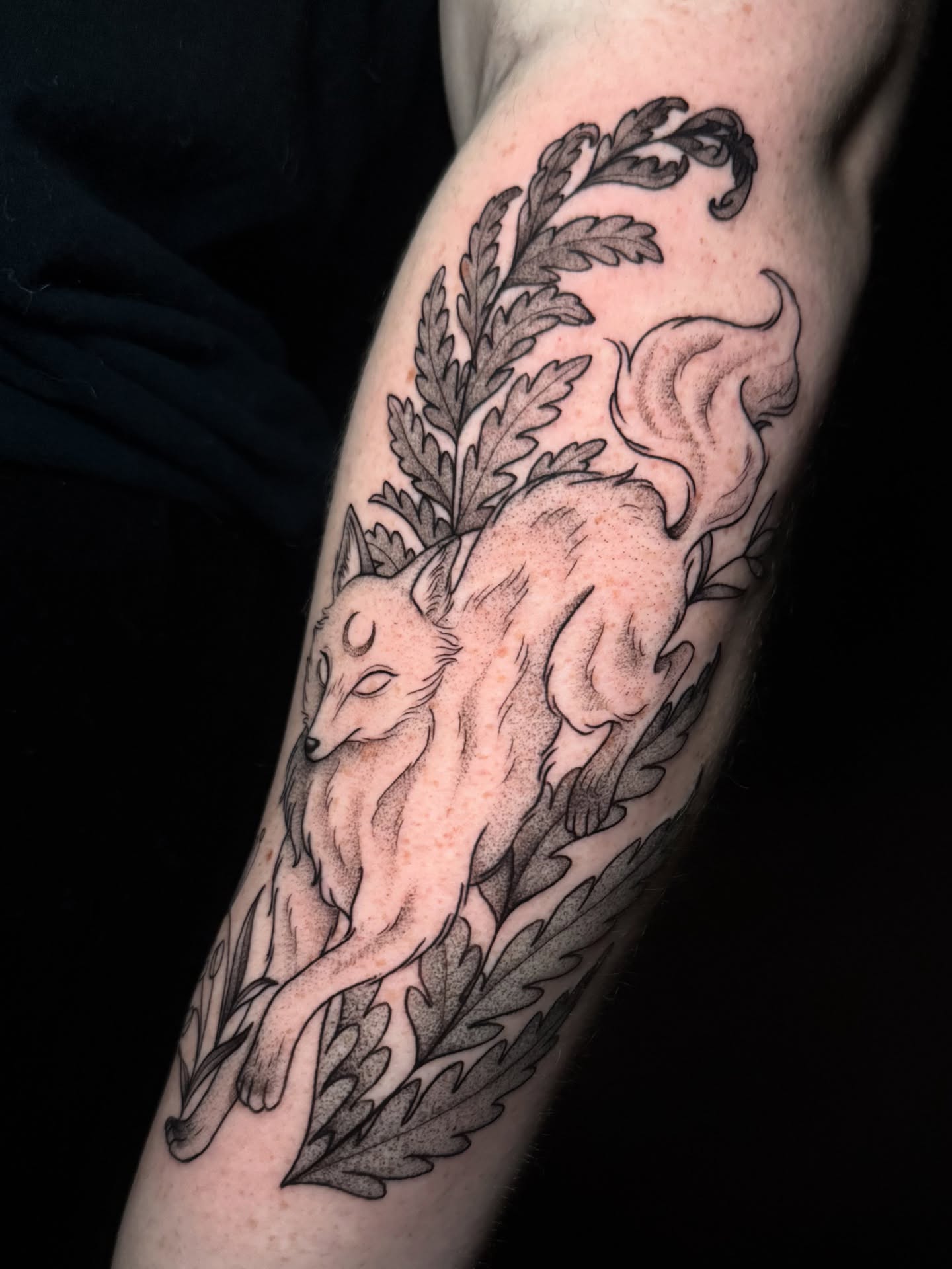 Fox and fern black and grey tattoo on the forearm by Lauren B