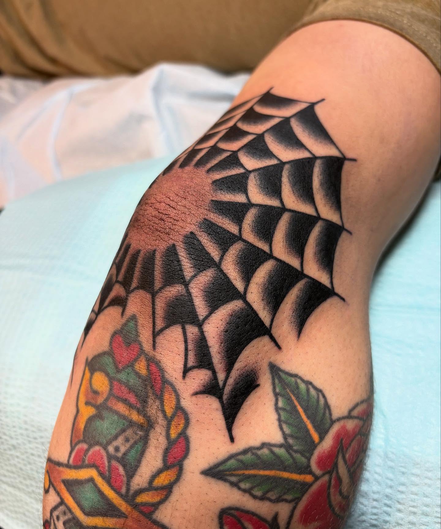 Spiderweb American traditional tattoo on the forearm by Tom Wenzell