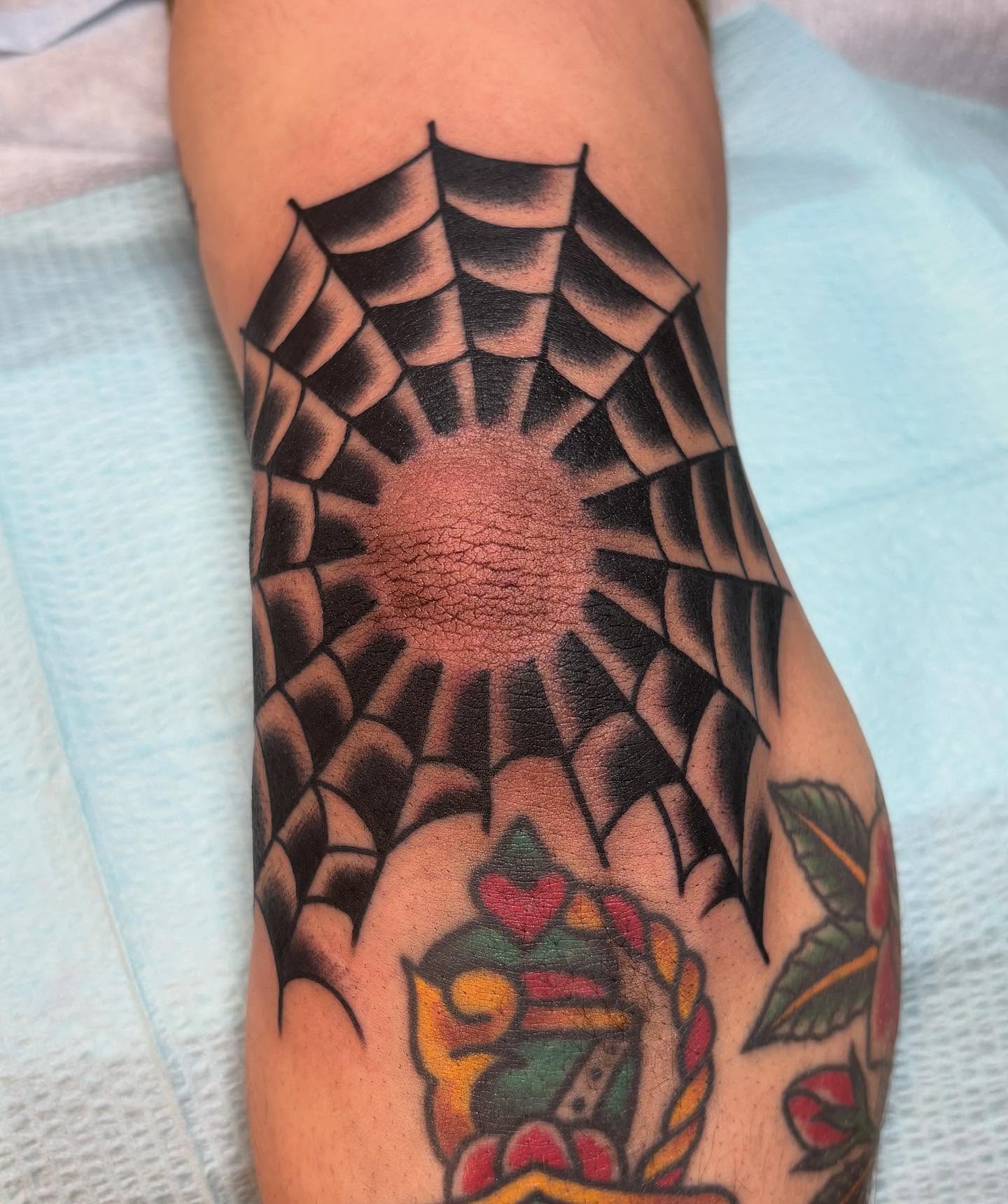 Spider web American traditional tattoo on the forearm by Tom Wenzell
