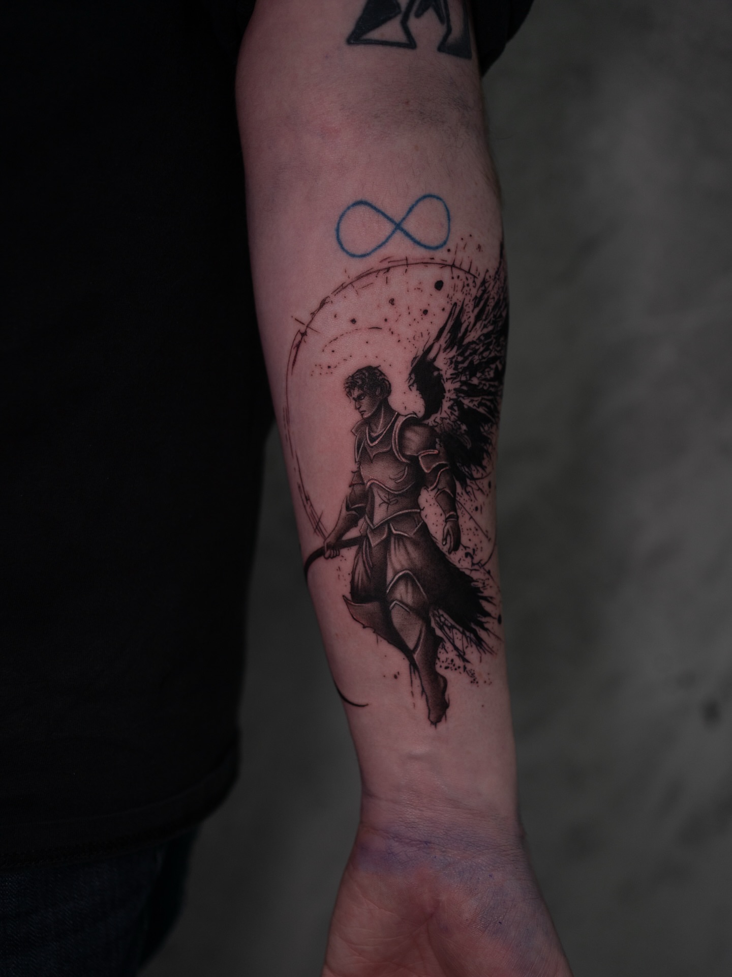 Angel with staff realism tattoo on the forearm by Damon Valdez