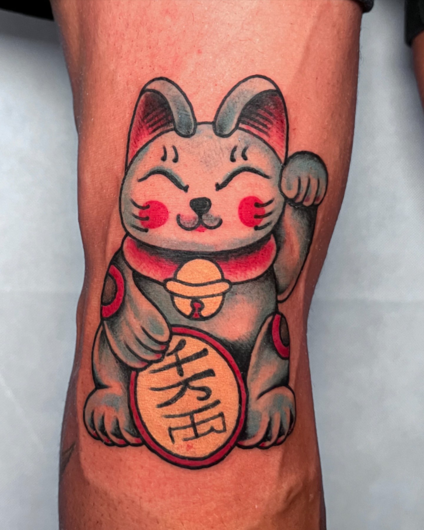 Maneki-neko American traditional tattoo on the forearm by Alessandro Pennella