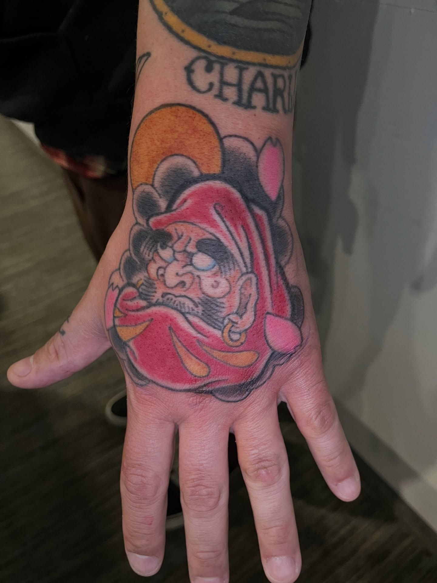 Jester American traditional tattoo on the hand by Brian Easlon