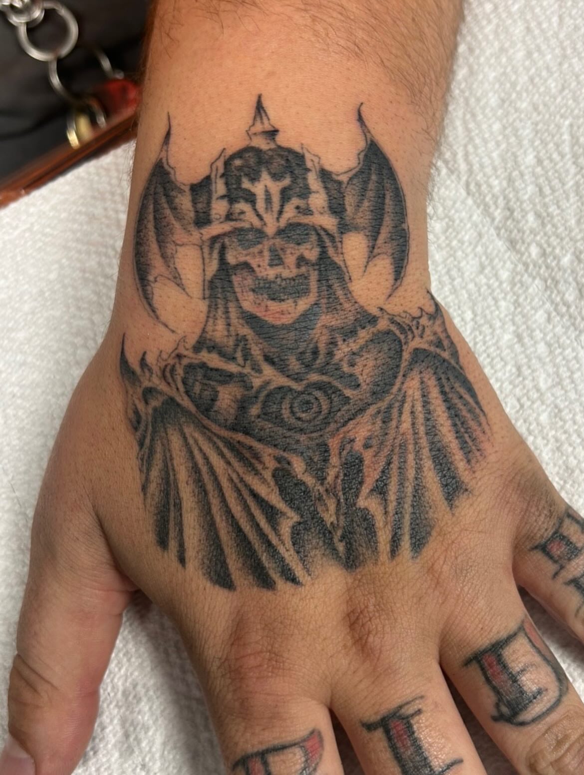 Demon dark realism tattoo on the hand by Alex Lang