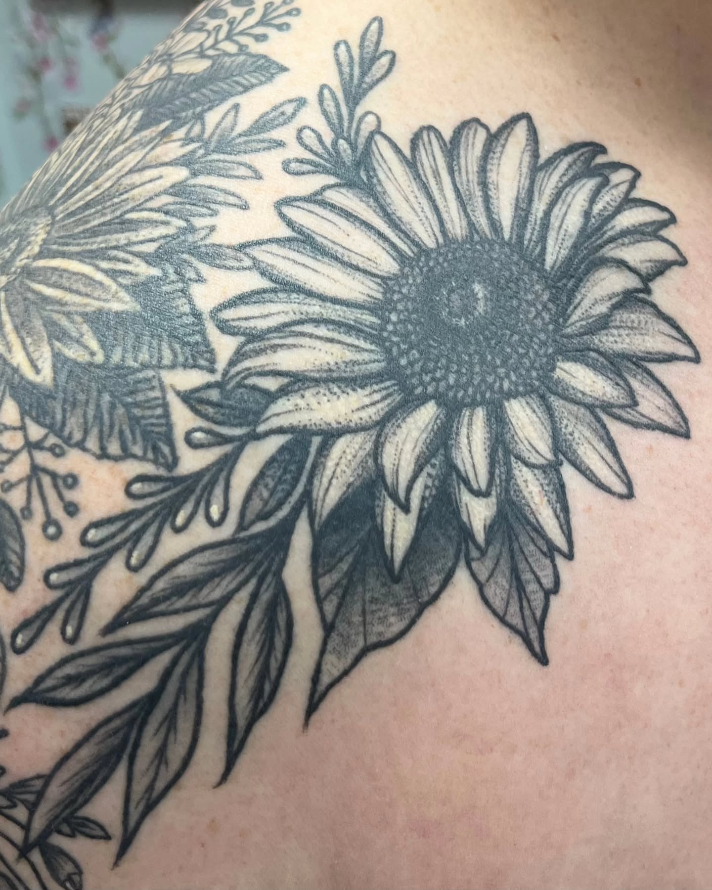 Sunflower dotwork tattoo on the shoulder by Garden Glow Tattoo