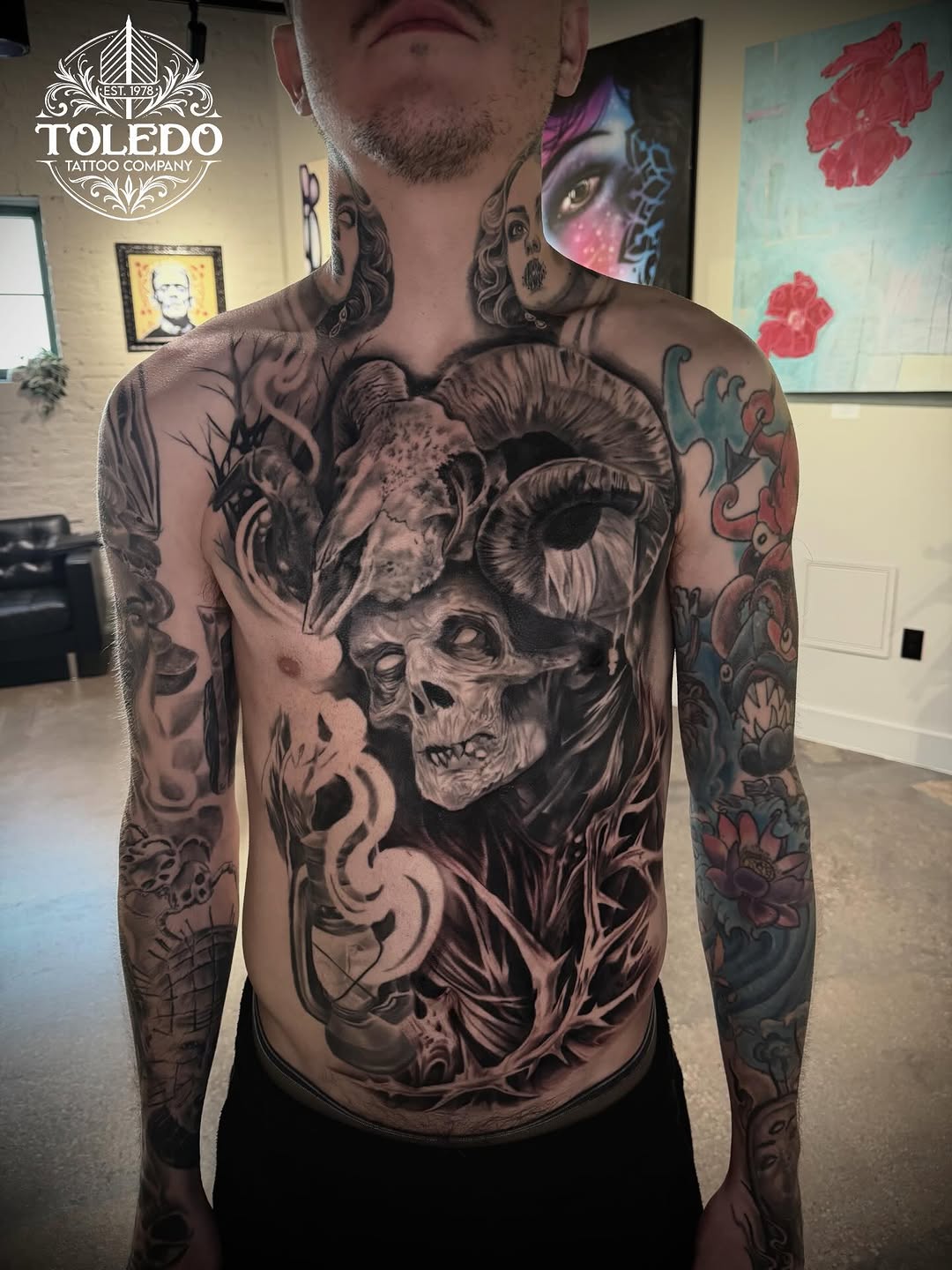 Skull and ram horns with lantern realism tattoo on the chest by Kodi Klo