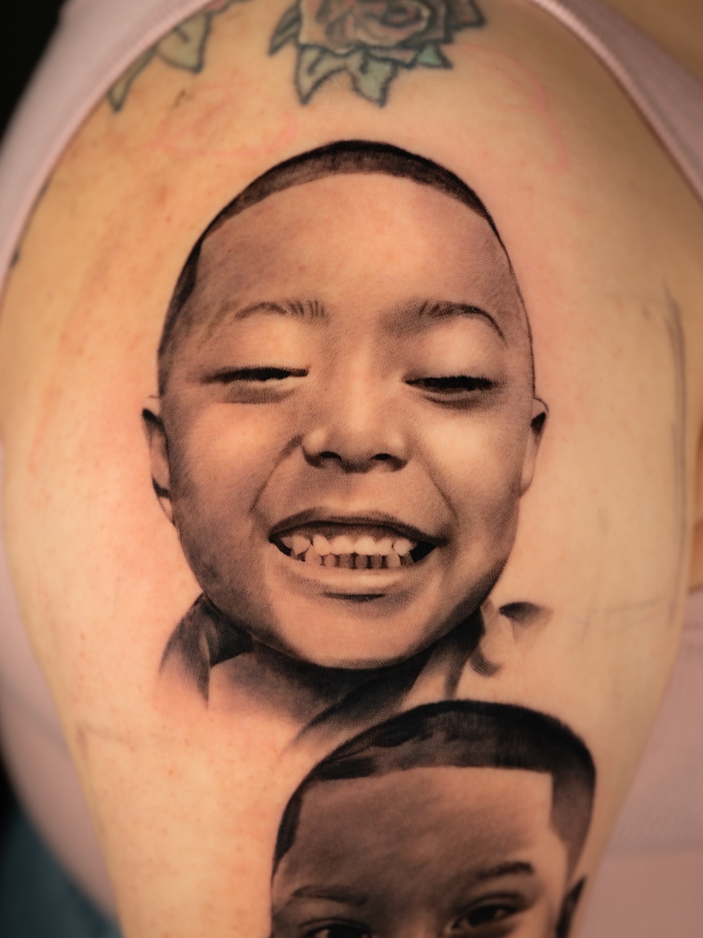 Child's face realism tattoo on the forearm by Luis Rodriguez