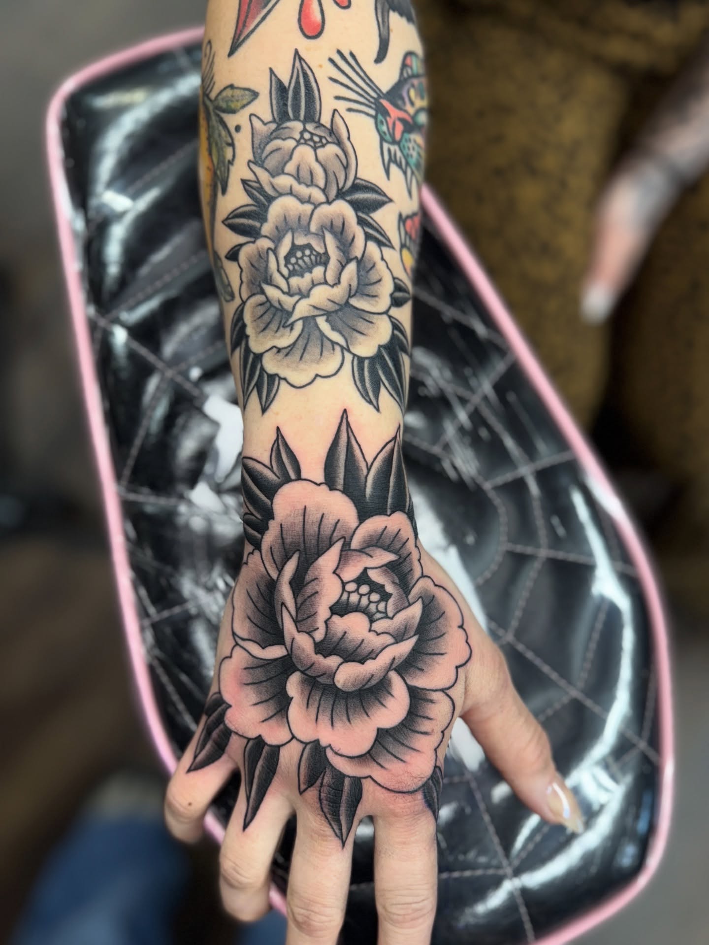 Peony black and grey tattoo on the hand by Sarah Pham