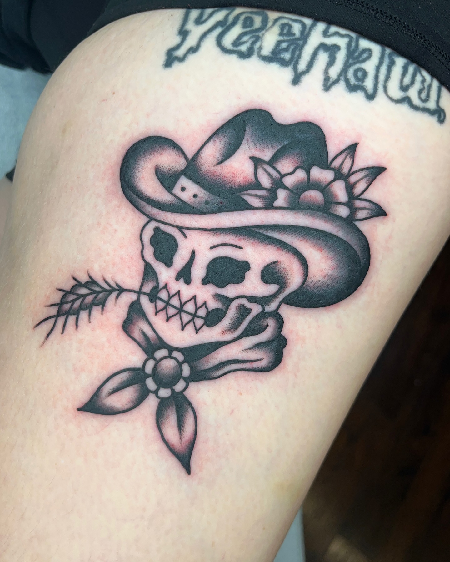 Cowboy skull American traditional tattoo on the thigh by Nat Power
