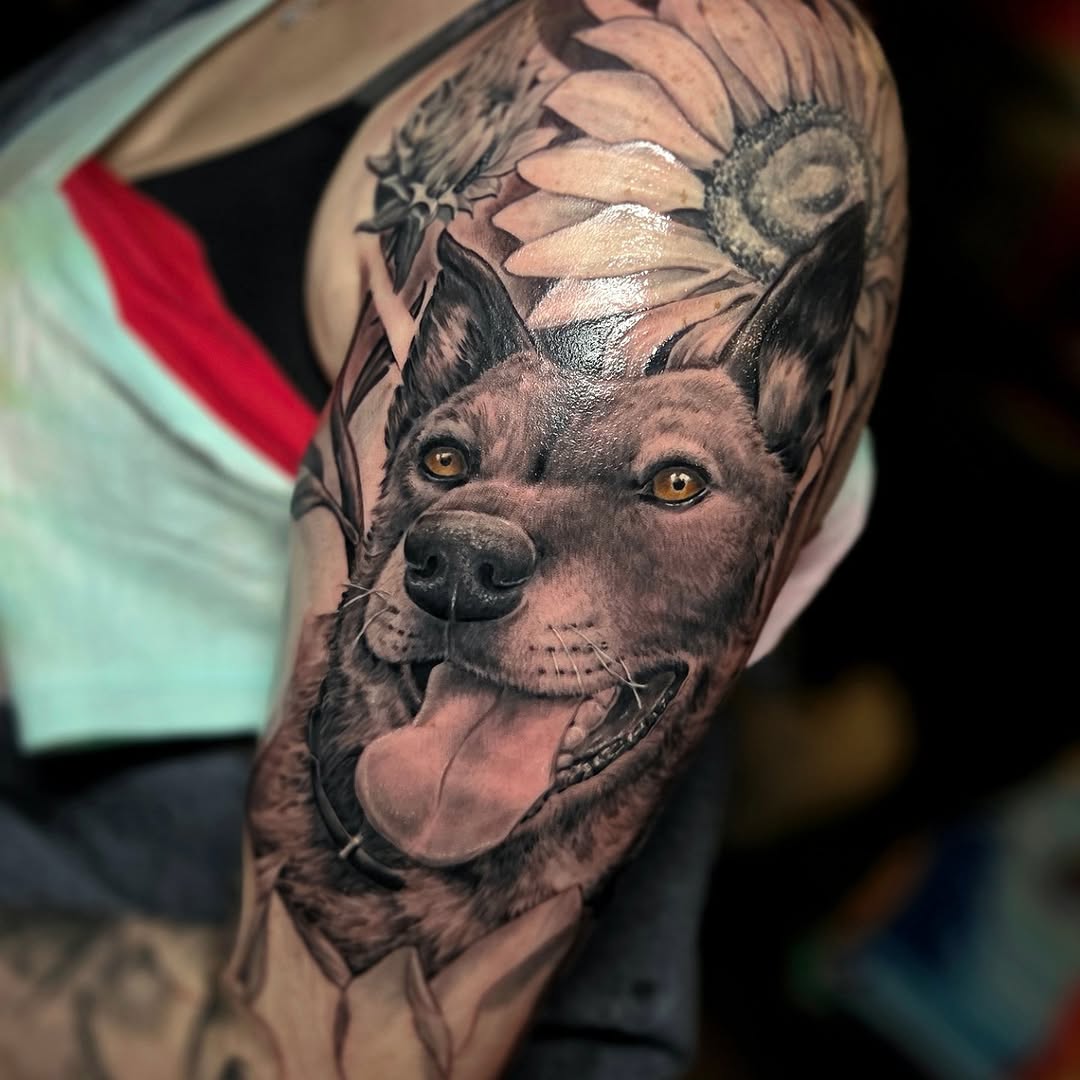 Dog portrait with sunflowers realism tattoo on the upper arm by Jake Goss, Salt Lake City, Utah