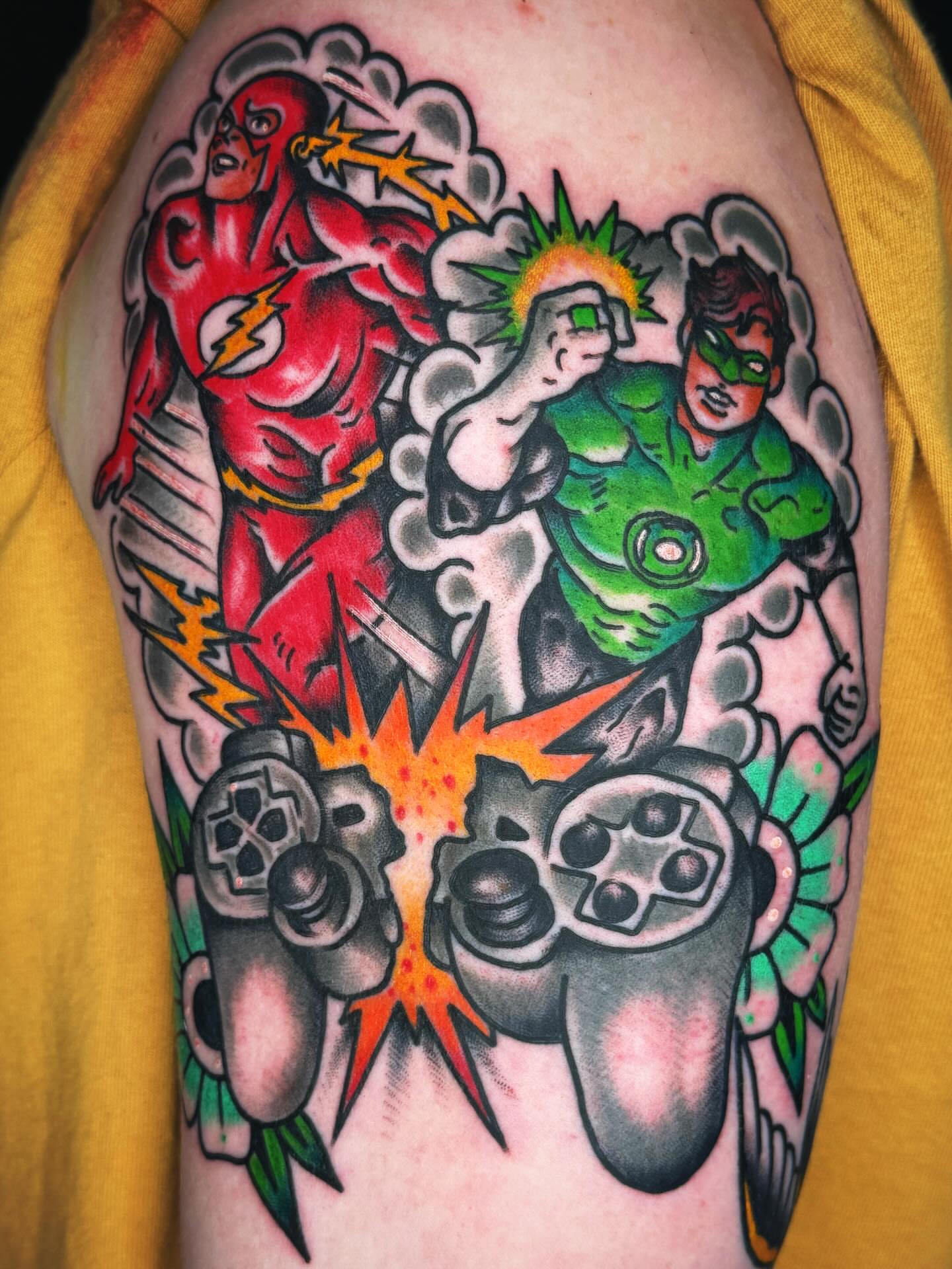Superheroes and video game controllers American traditional tattoo on the forearm by Mikey Sarratt
