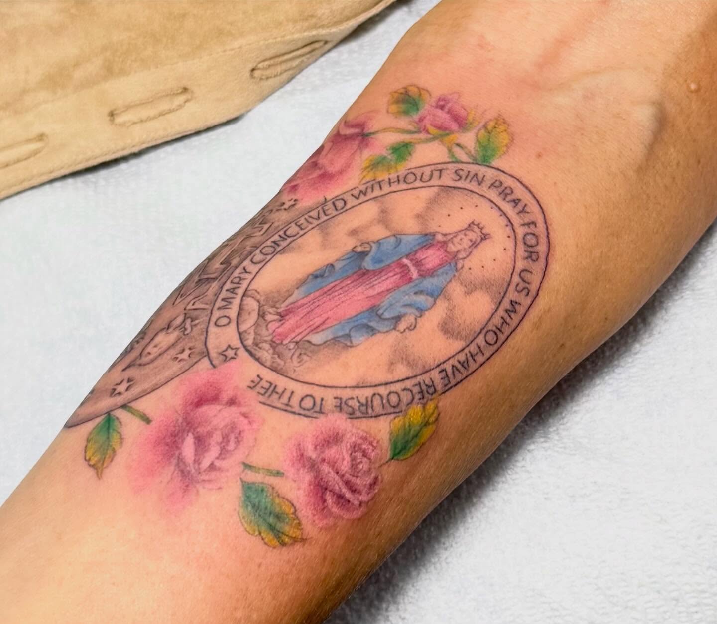 Our Lady of Lourdes watercolor tattoo on the forearm by Taylor Kay 🌿