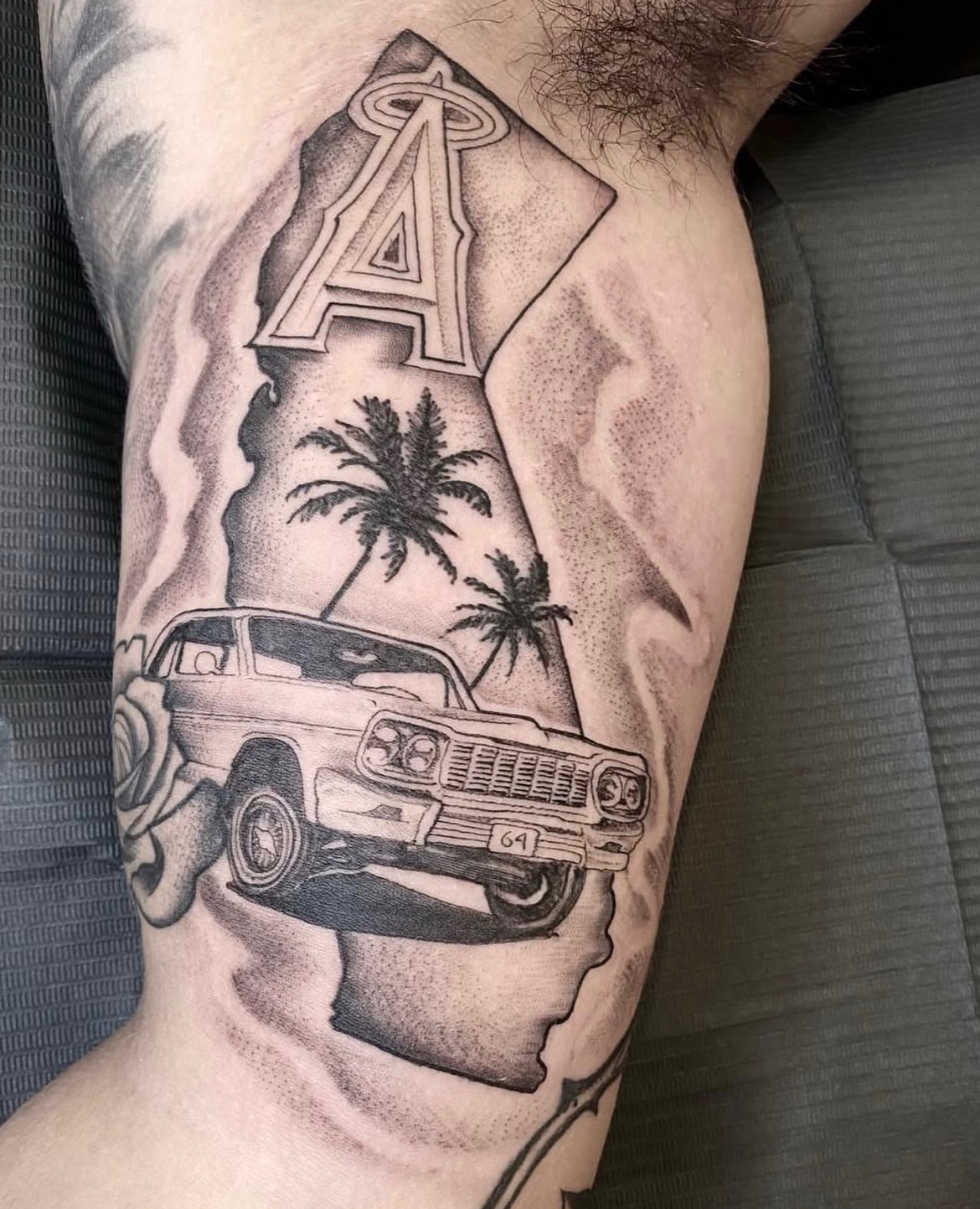 Car and palm trees dotwork tattoo on the thigh by Matthew Clanin