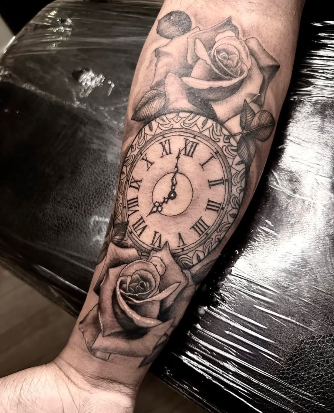 Clock and roses realism tattoo on the forearm by Matthew Clanin