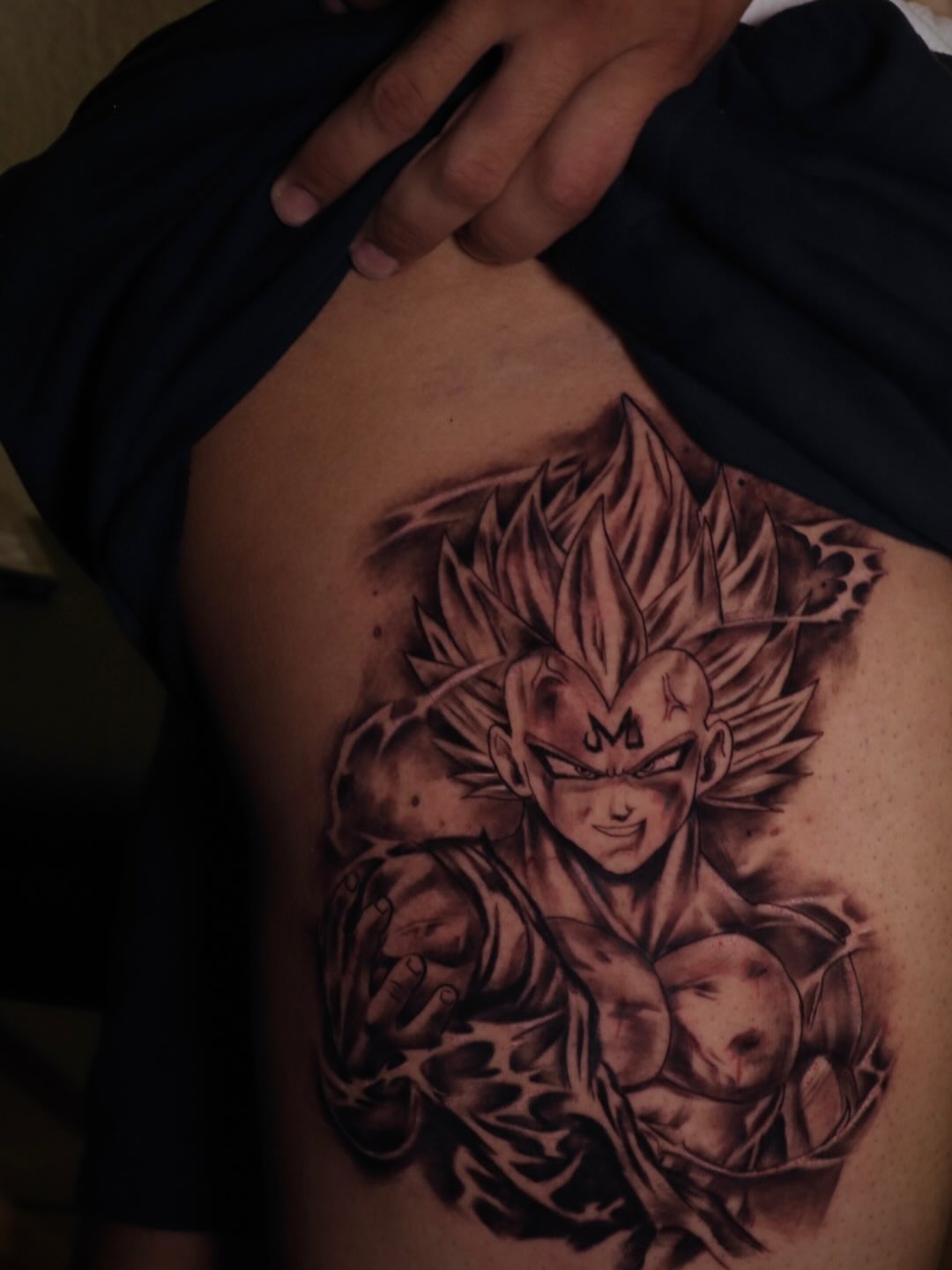 Super saiyan anime tattoo on the ribs by Mr Letters🗡️