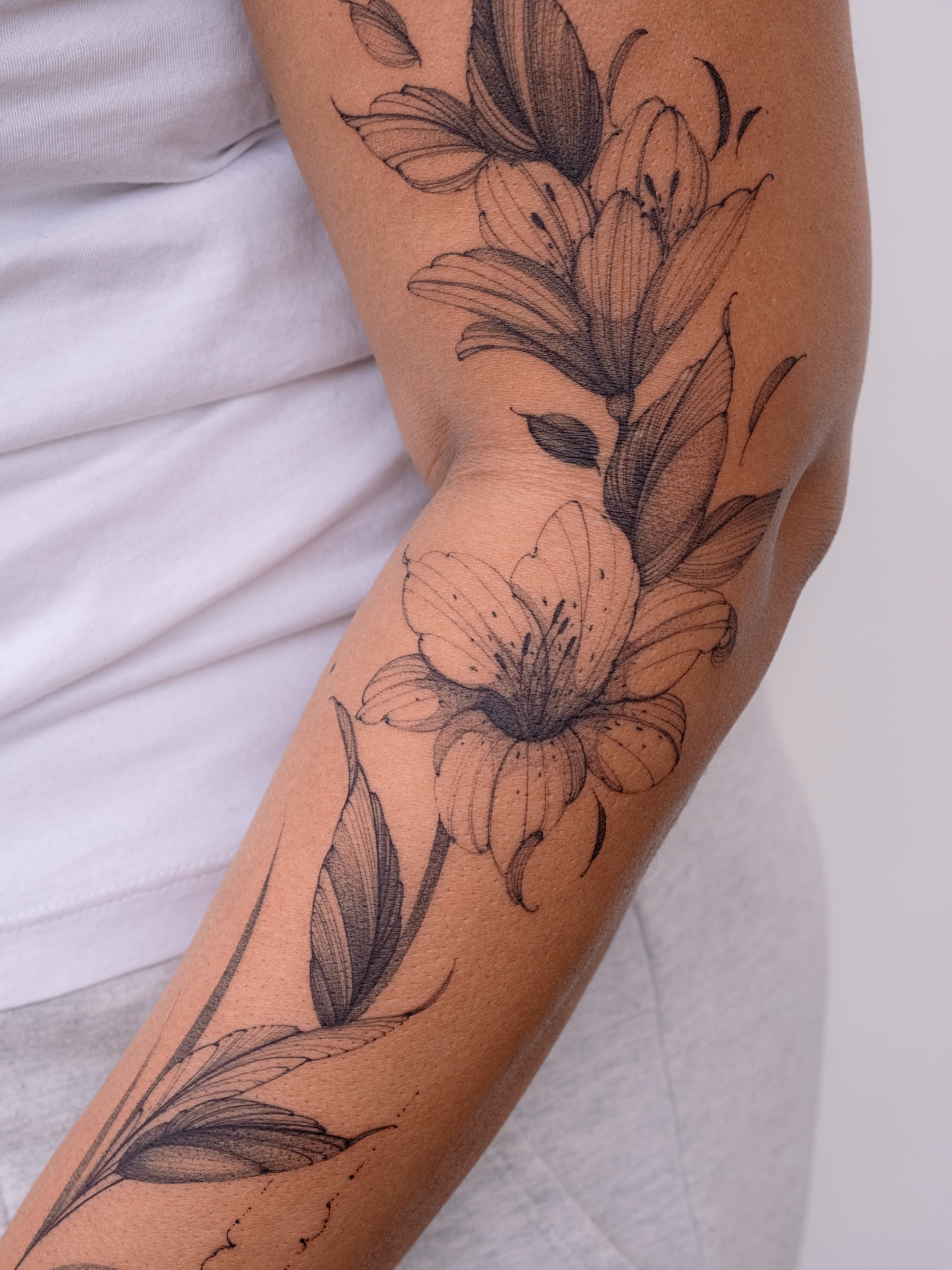 Lily flowers black and grey tattoo on the forearm by i flower you