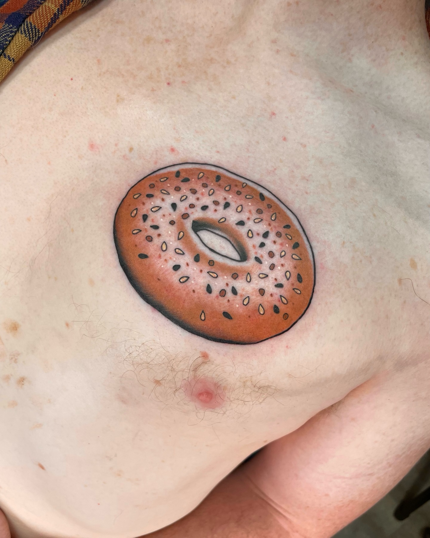 Bagel realism tattoo on the chest by 𝕬𝖓𝖆𝖇𝖊𝖑𝖑 𝕸𝖔𝖗𝖔