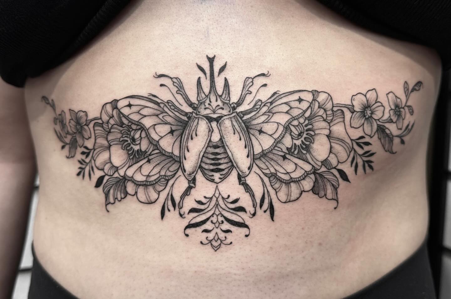 Beetle and floral ornamental tattoo on the ribs by Kirsten Marsden Ballantyne